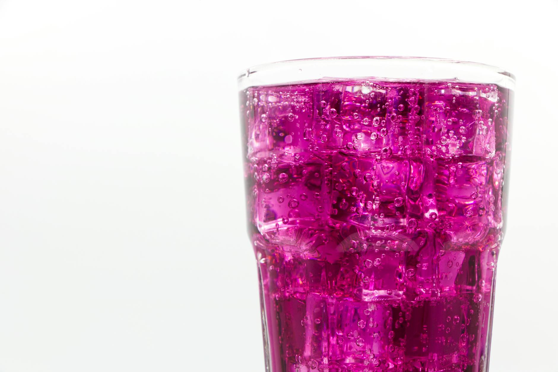 a glass of purple drink in close up shot