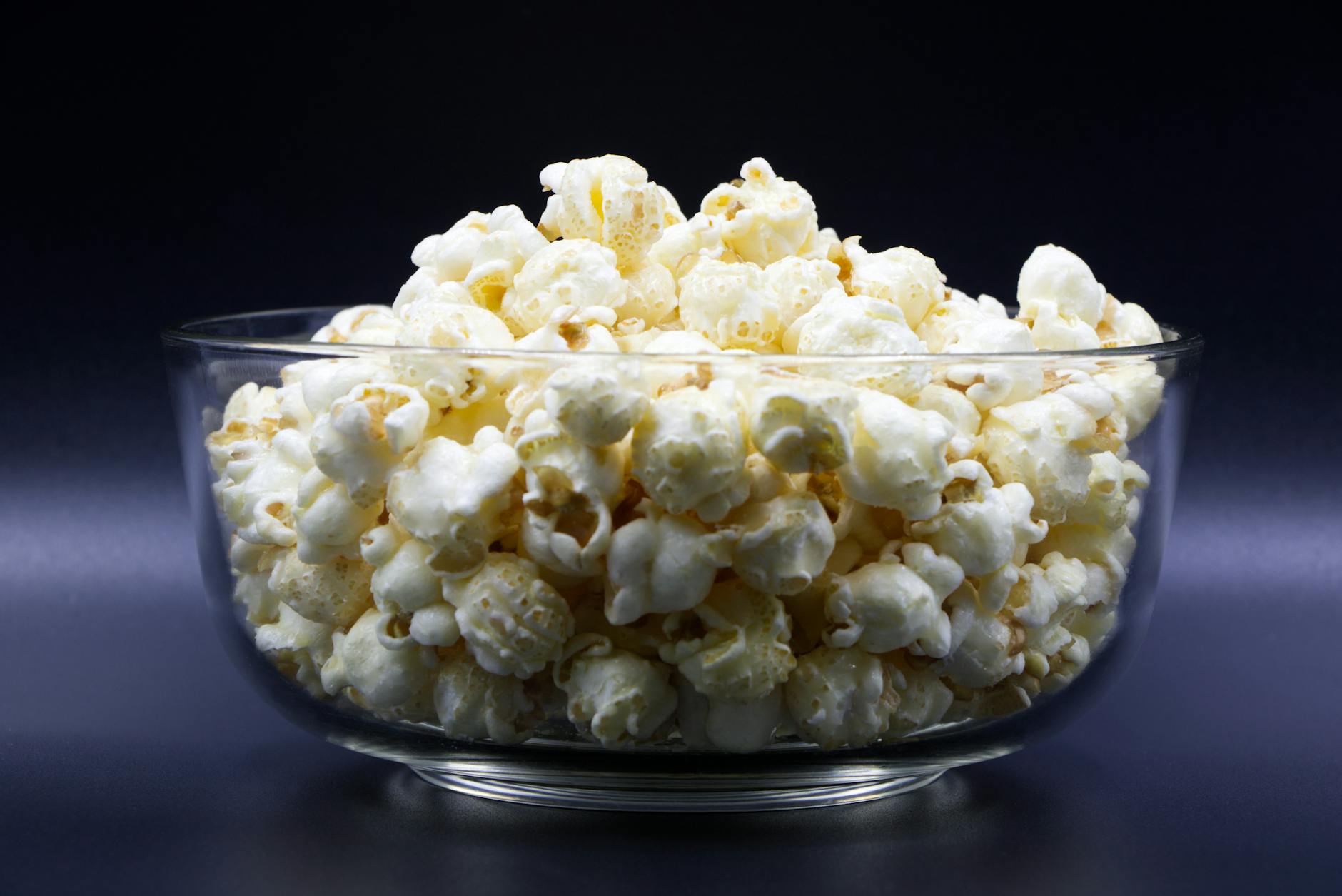 a glass bowl filled with popcorn