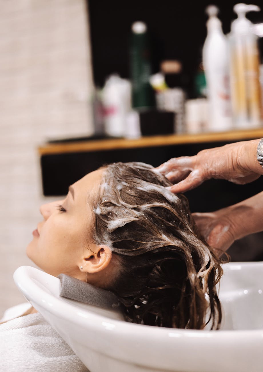 washing woman hair at hairdresser