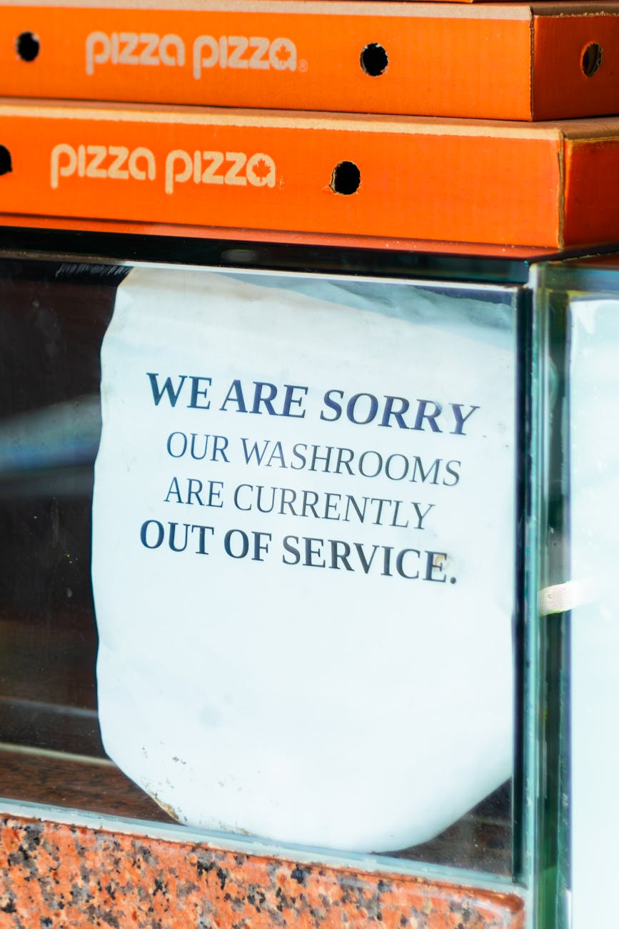 signage display of pizza boxes and service notice