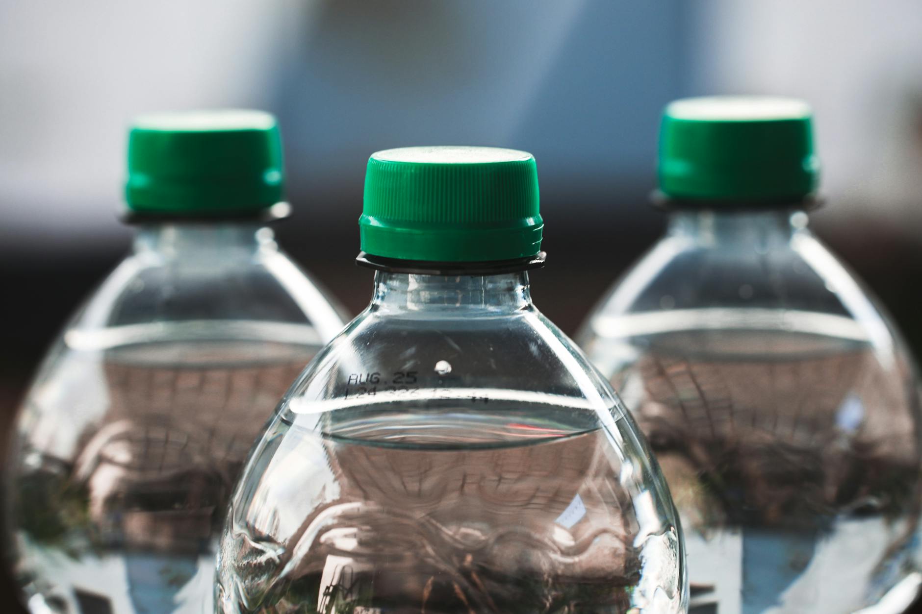 close up of plastic bottles with green caps