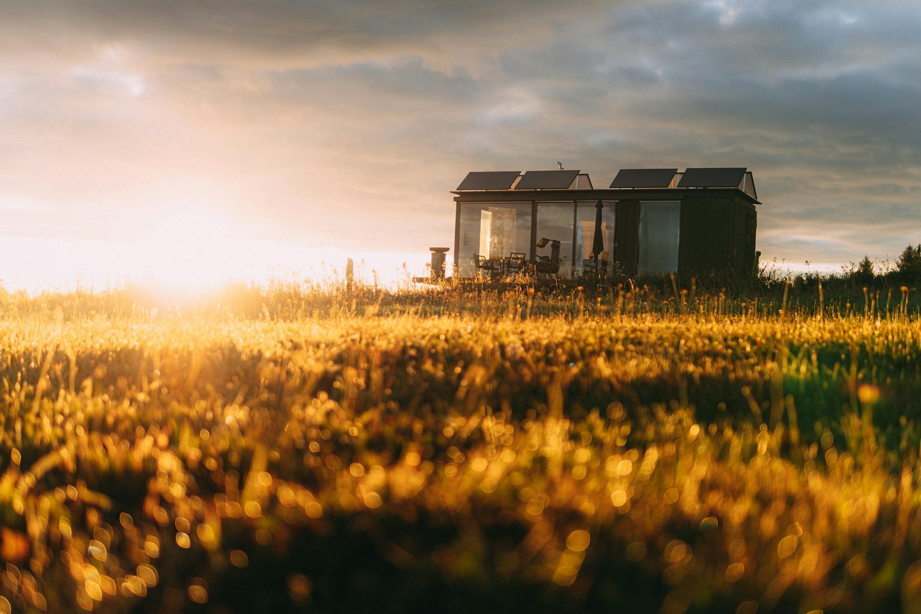 cozy tiny house at sunset with solar panels