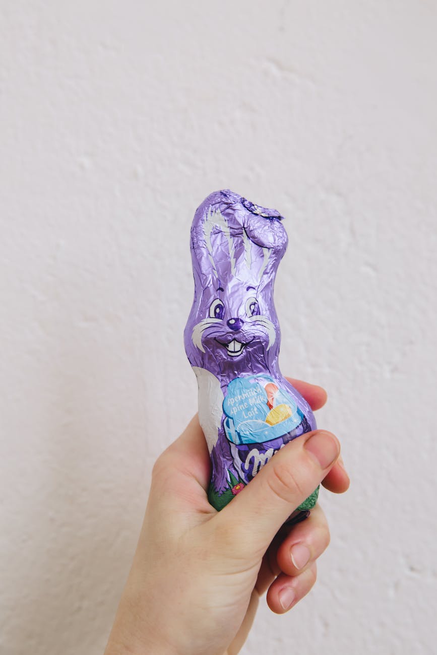 person holding a chocolate easter bunny