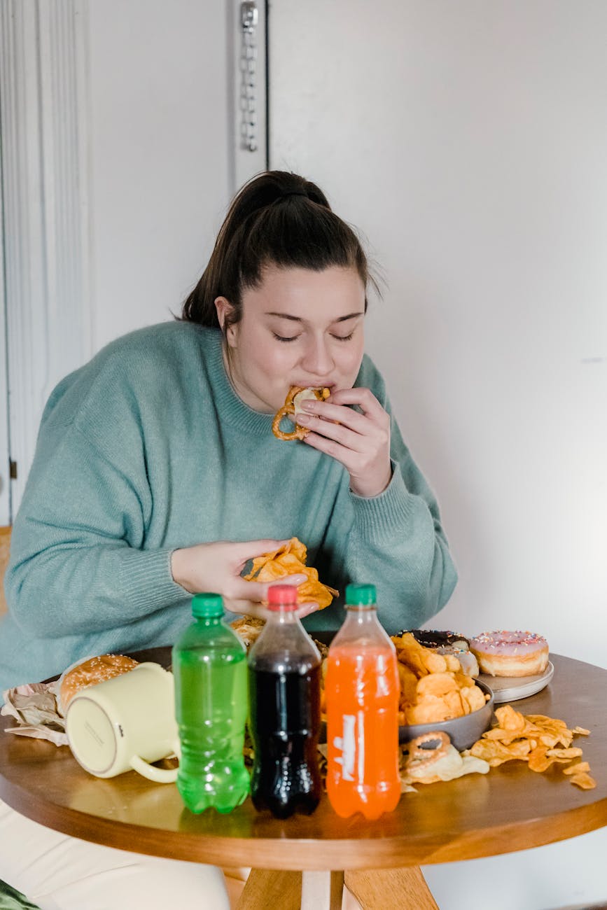 hungry woman eating junk food