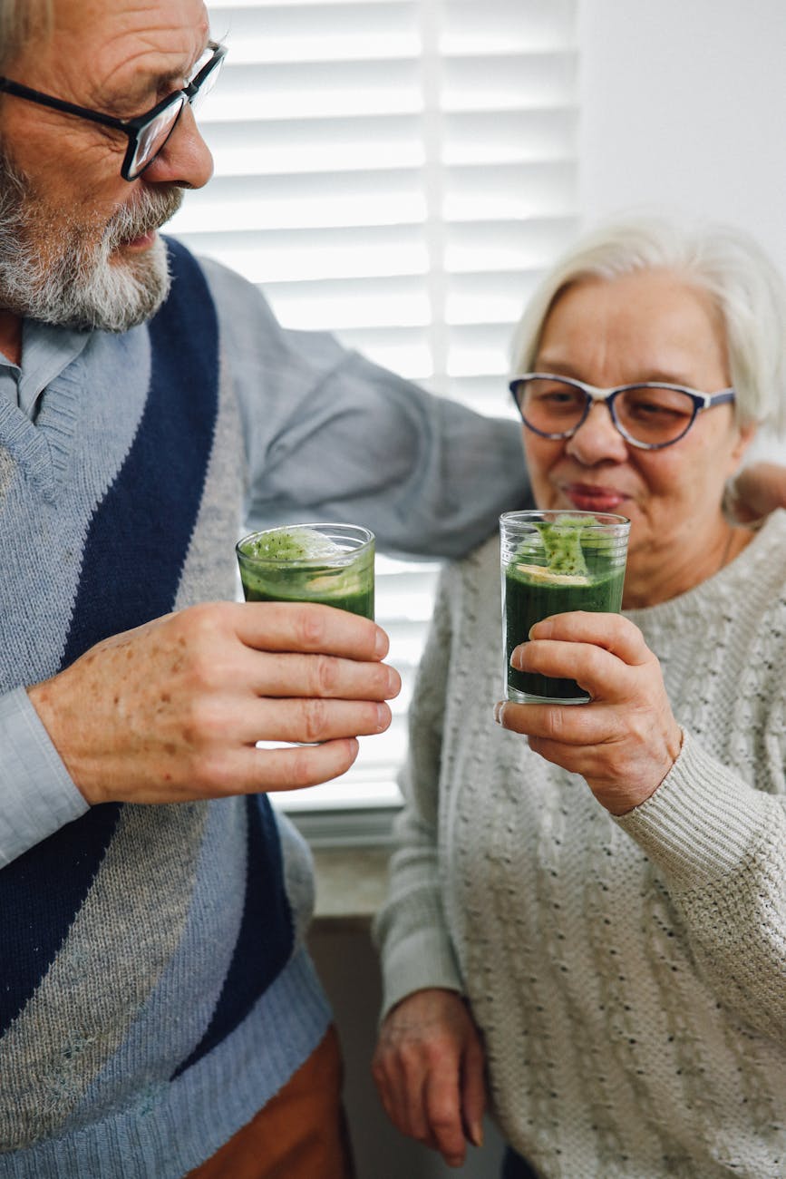elderly couple drinking green juice