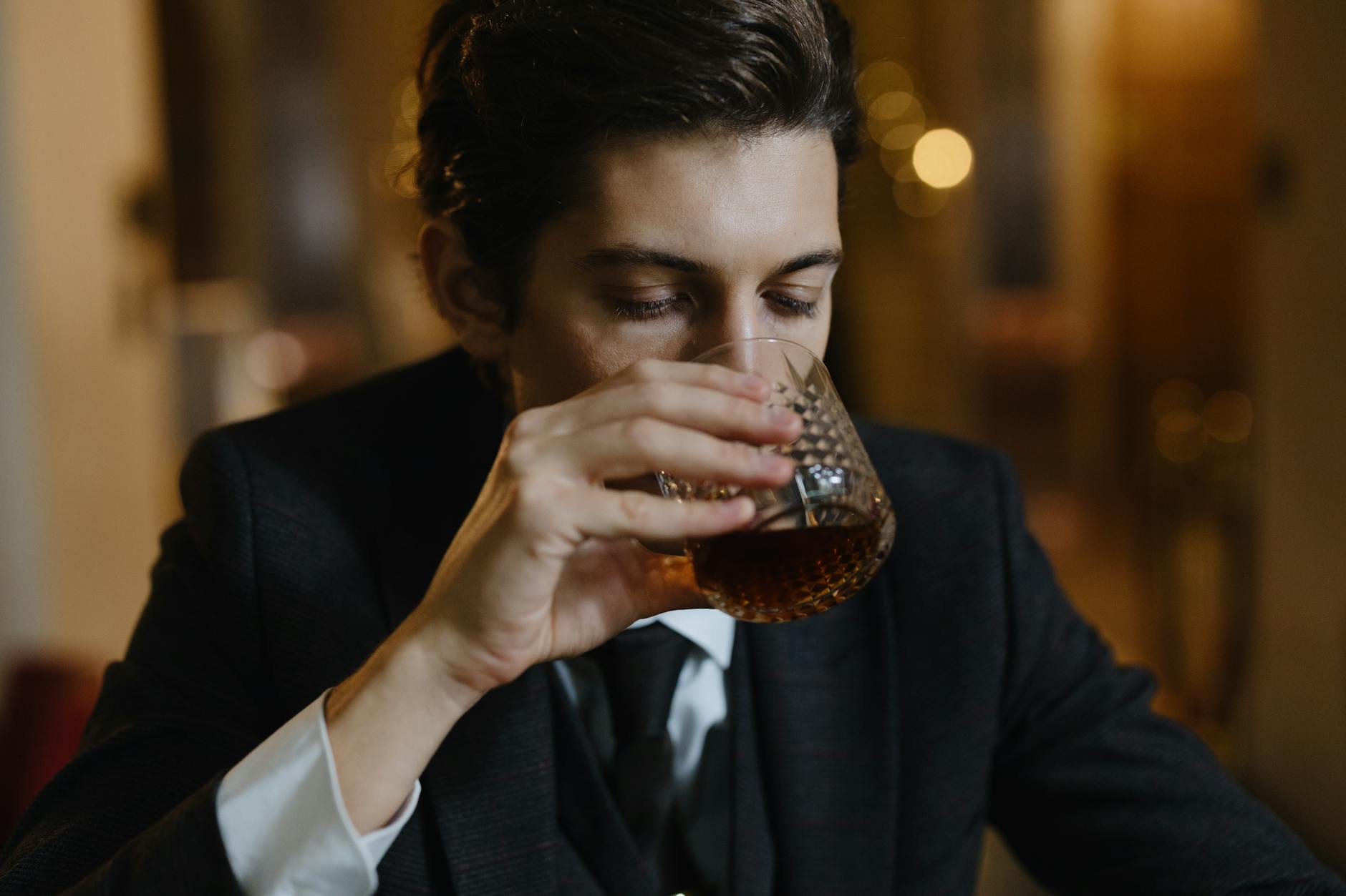 photo of a man drinking whiskey