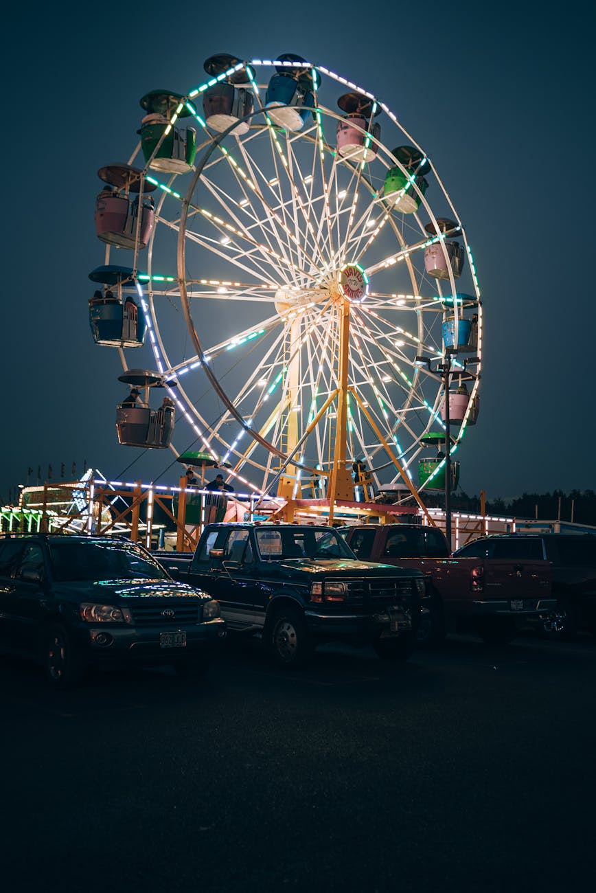parked cars on the lot near an amusement park