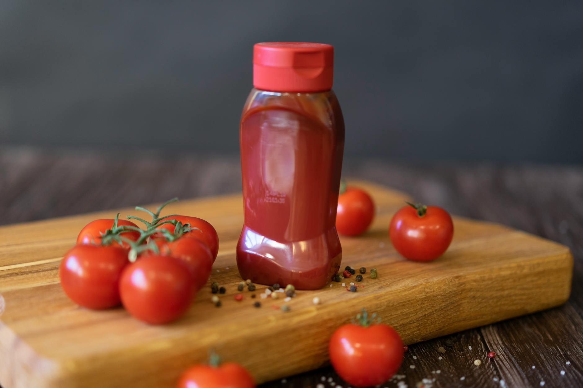 red tomatoes on wooden chopping board