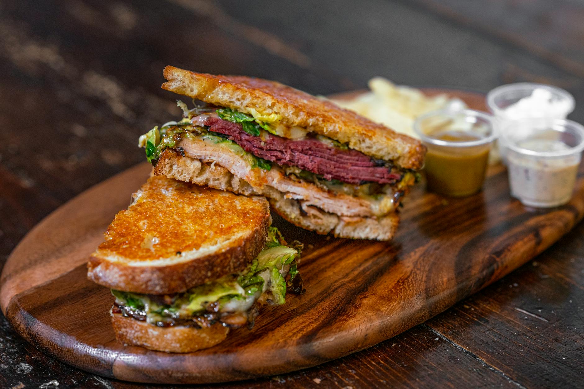 photo of sandwiches with meat on a cutting board