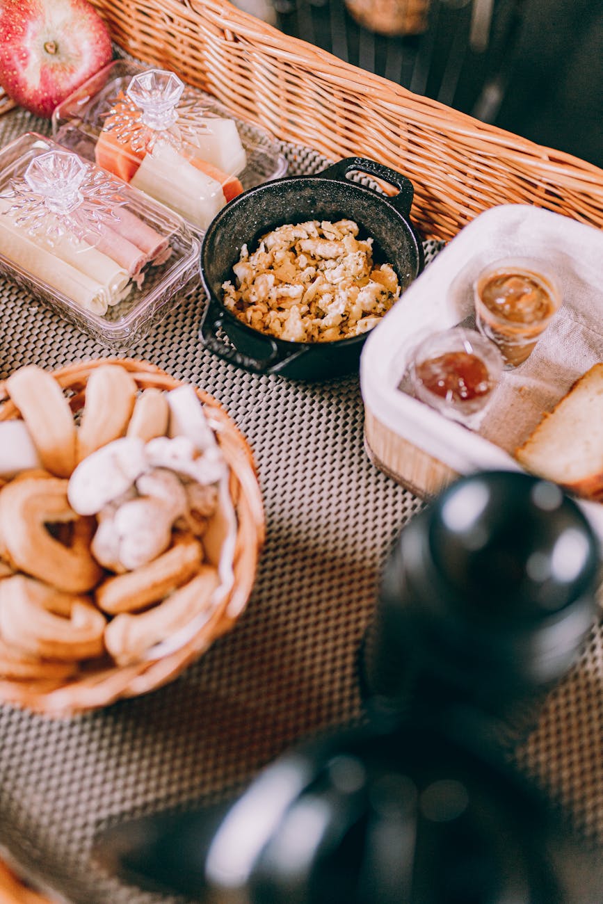 a picnic basket with food and drinks on a table