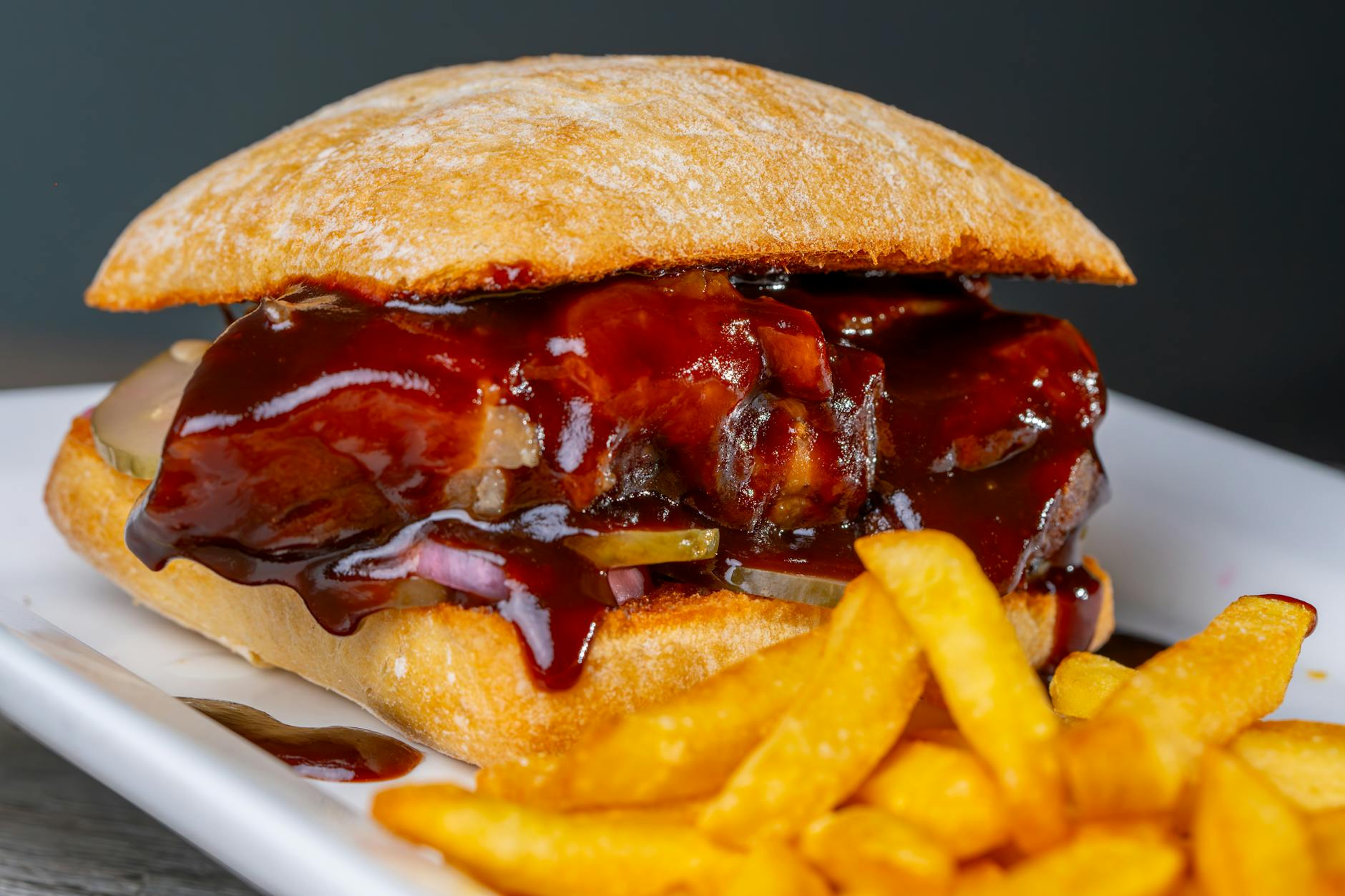 delicious bbq sandwich with fries on plate