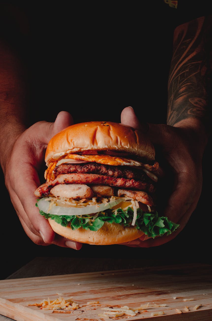 gourmet beef burger with lettuce on wooden board