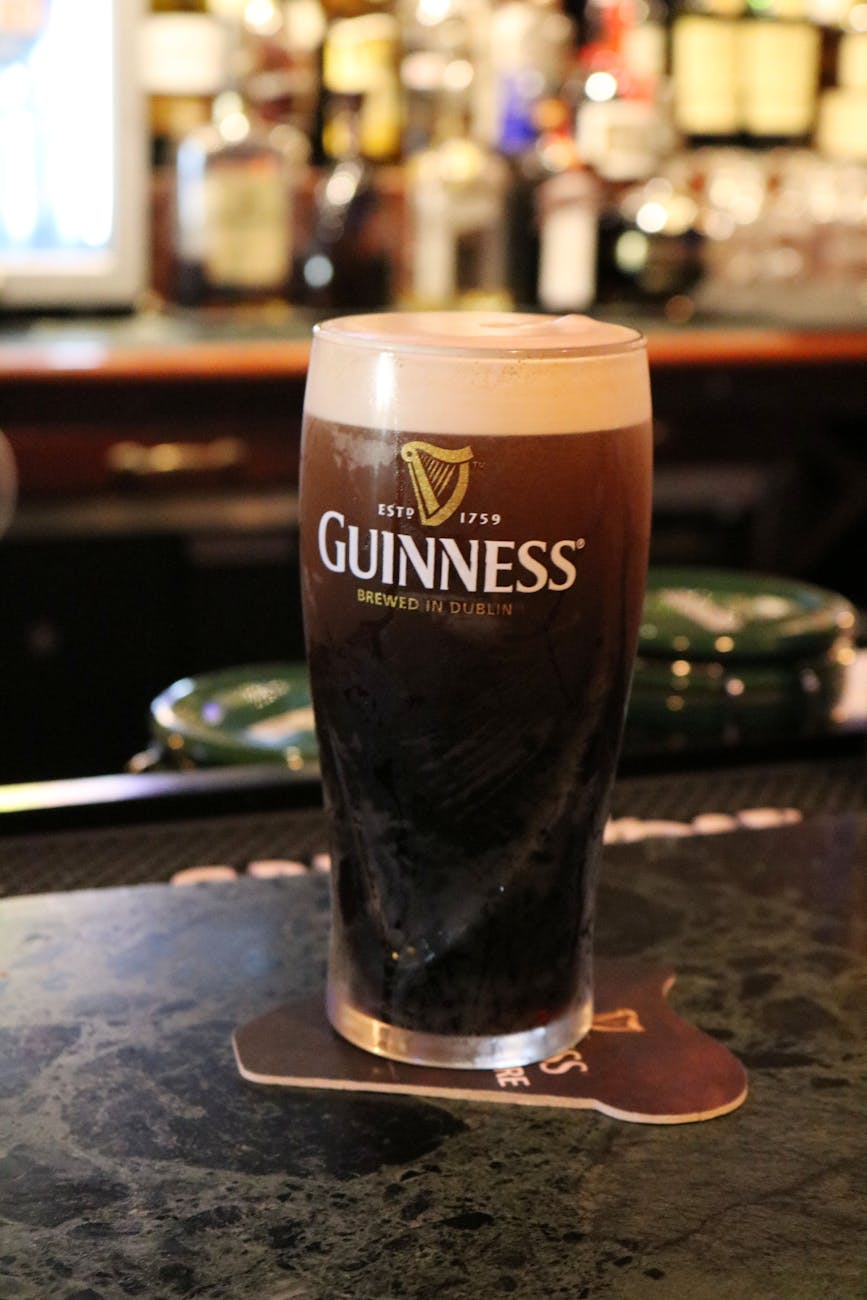 classic guinness beer glass on pub counter