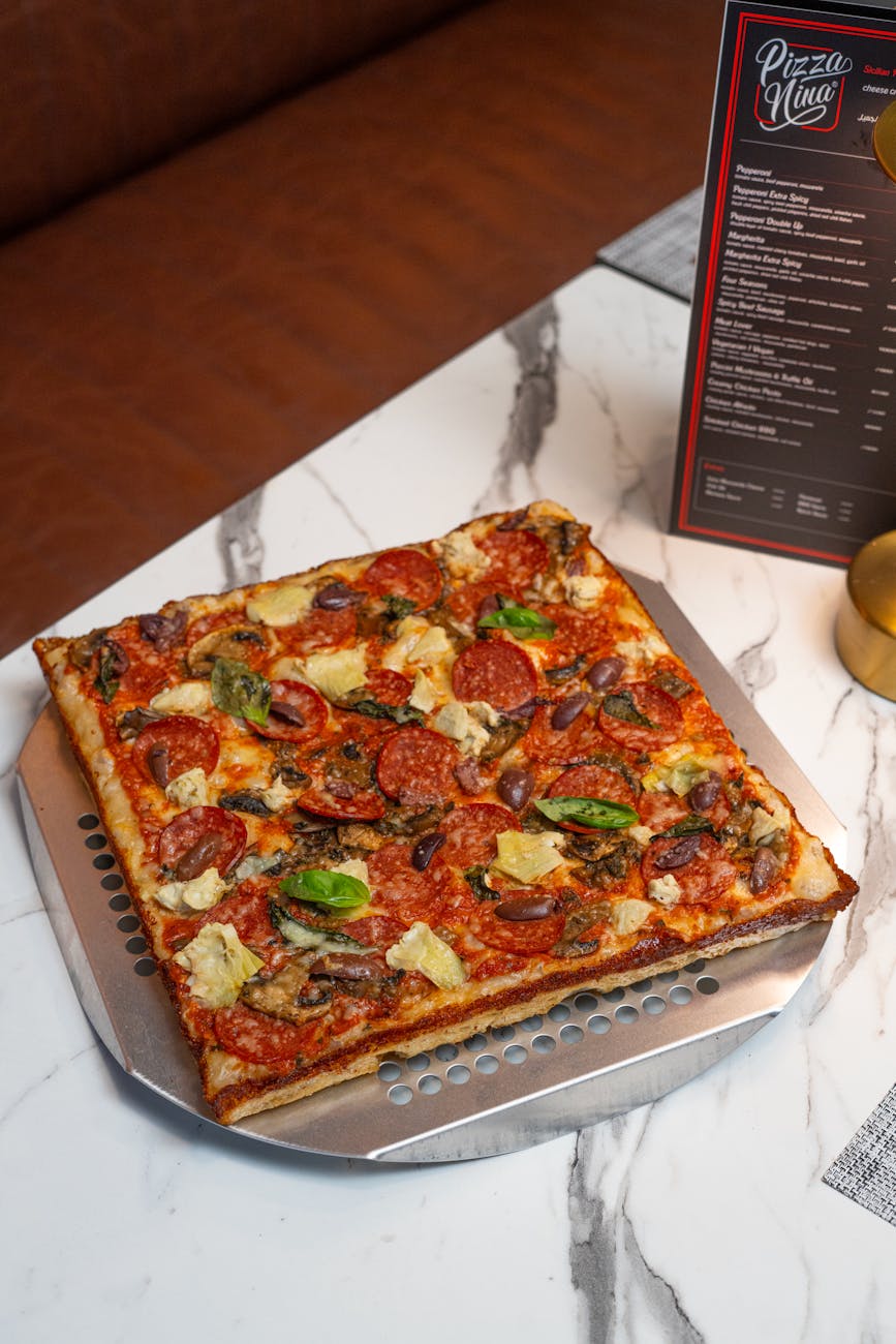 delicious square pizza with toppings in baghdadi restaurant