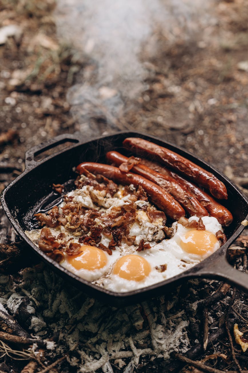 rustic campfire breakfast with eggs and sausages