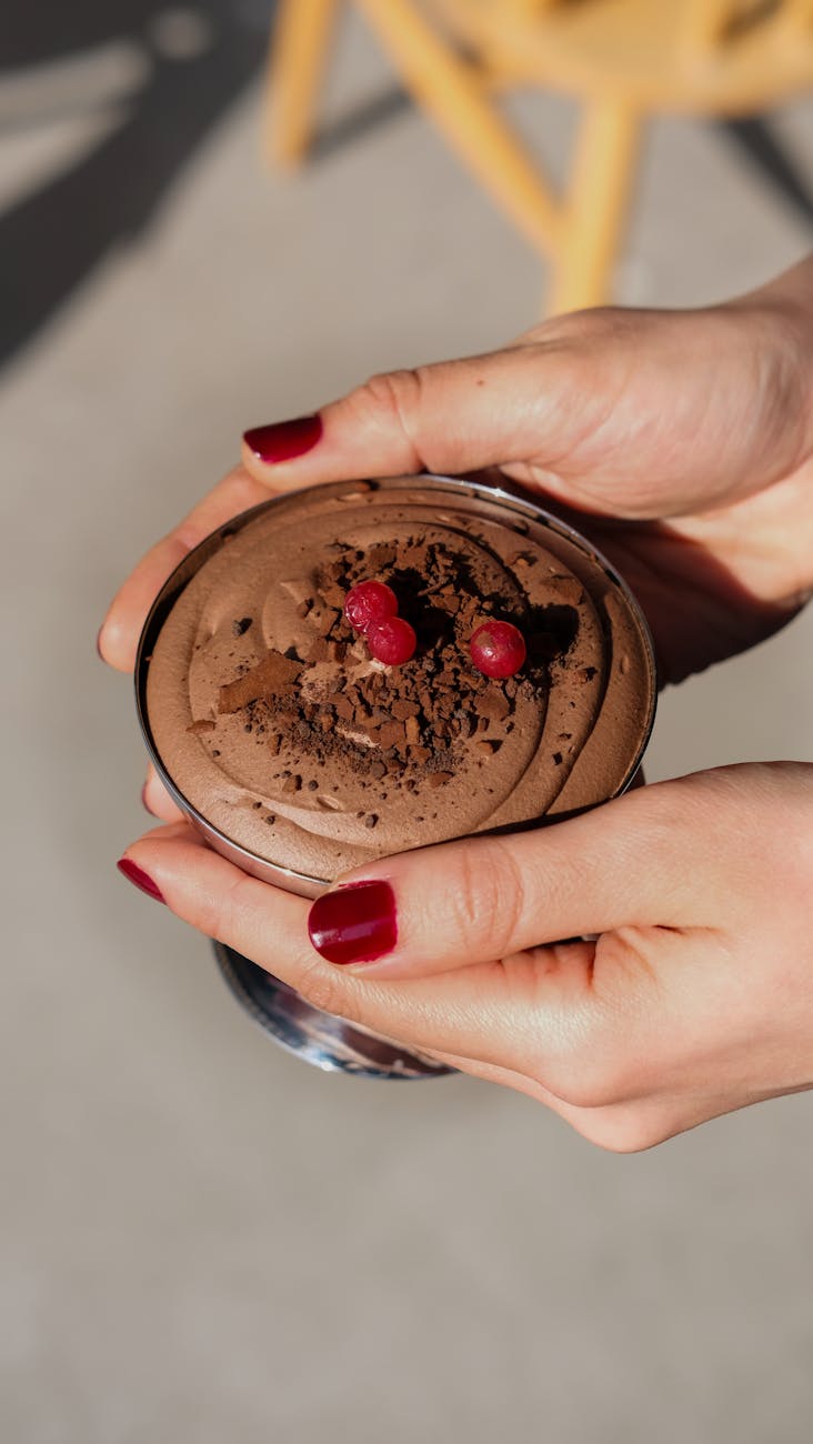 close up of hands holding chocolate dessert