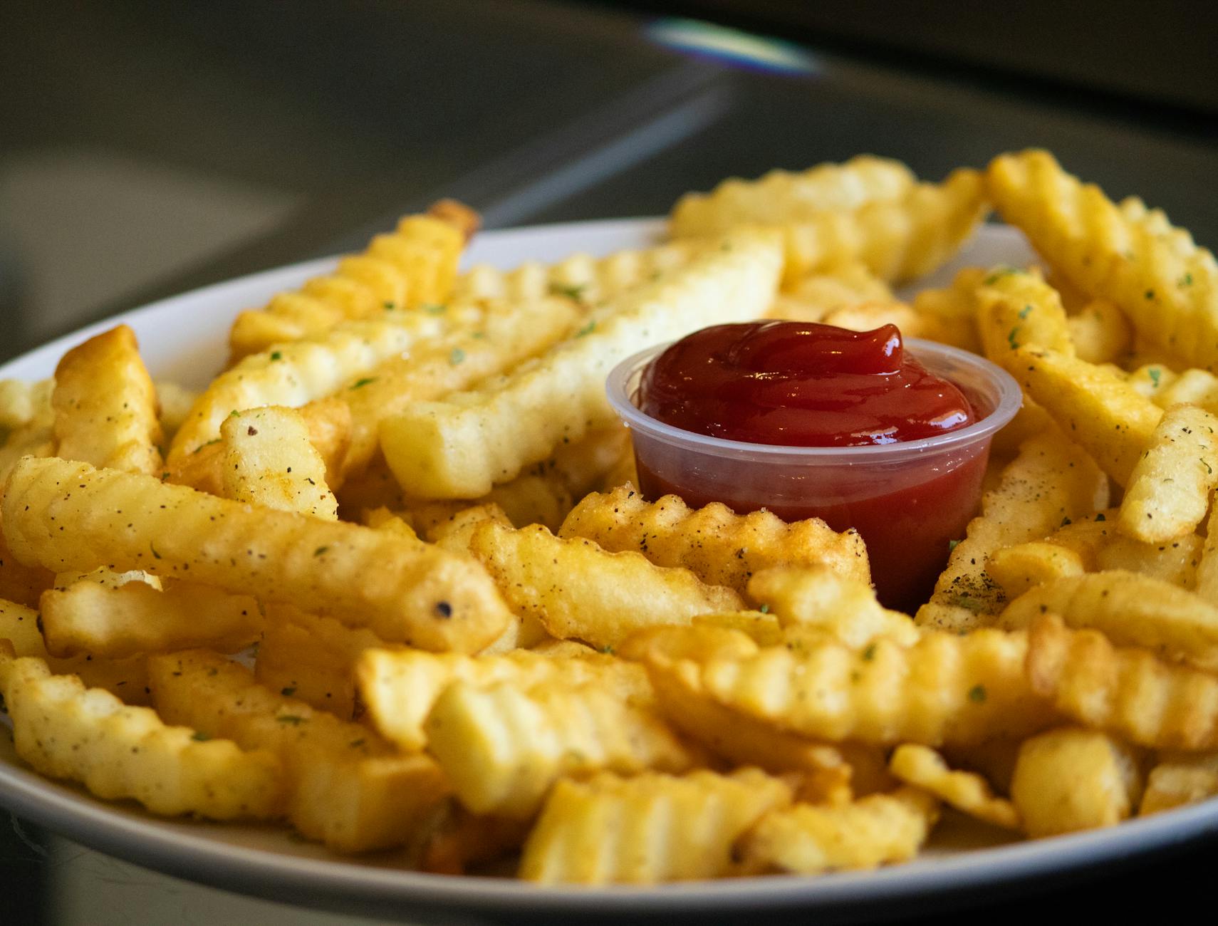 crispy french fries with ketchup on plate