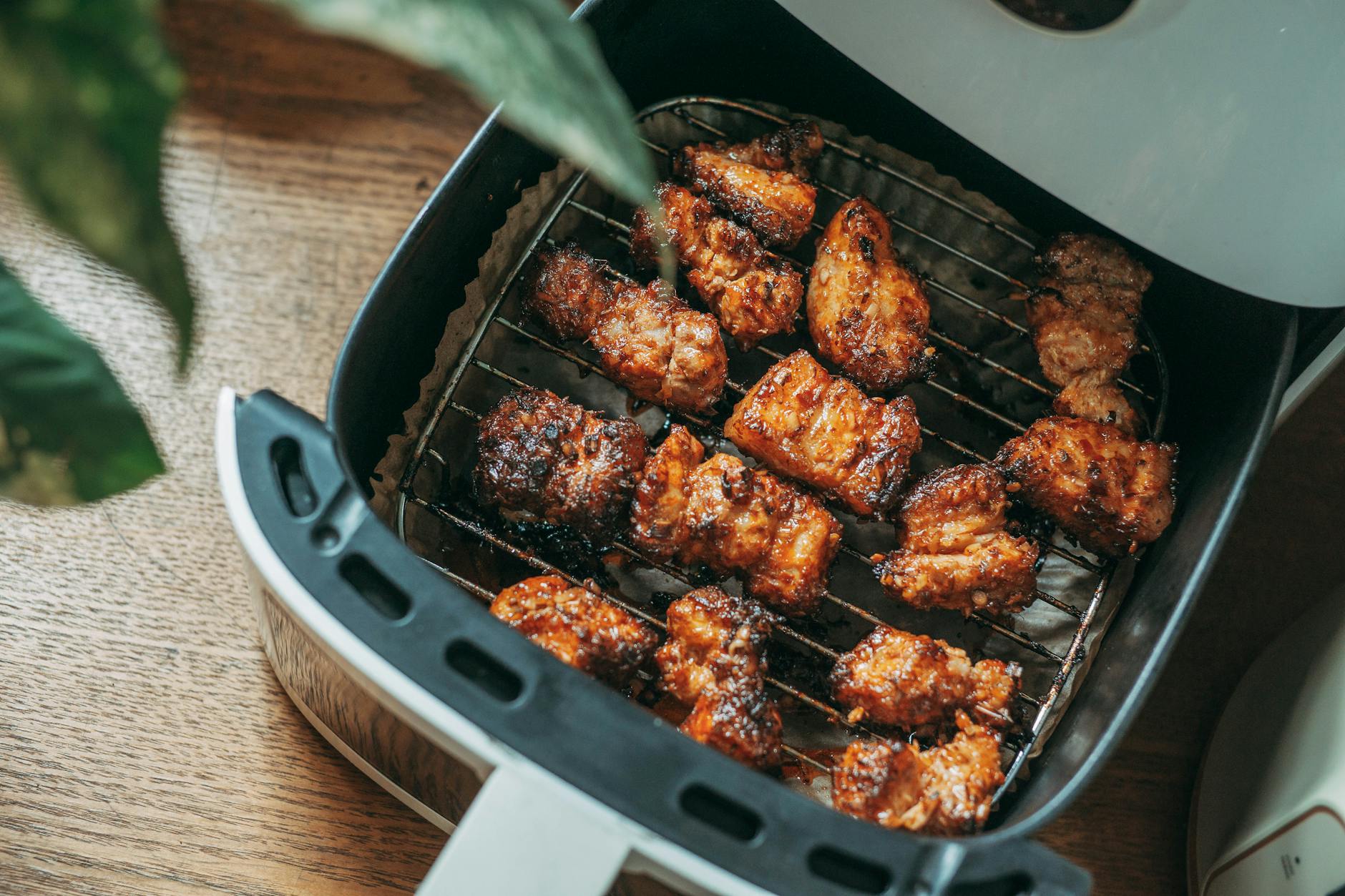 crispy chicken pieces in modern air fryer