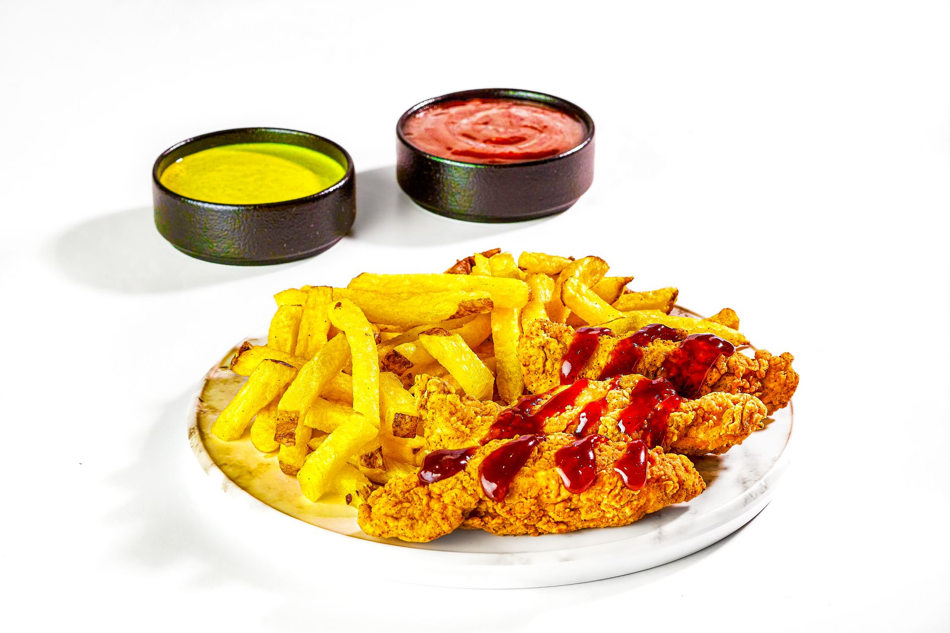 crispy chicken tenders and fries with sauces