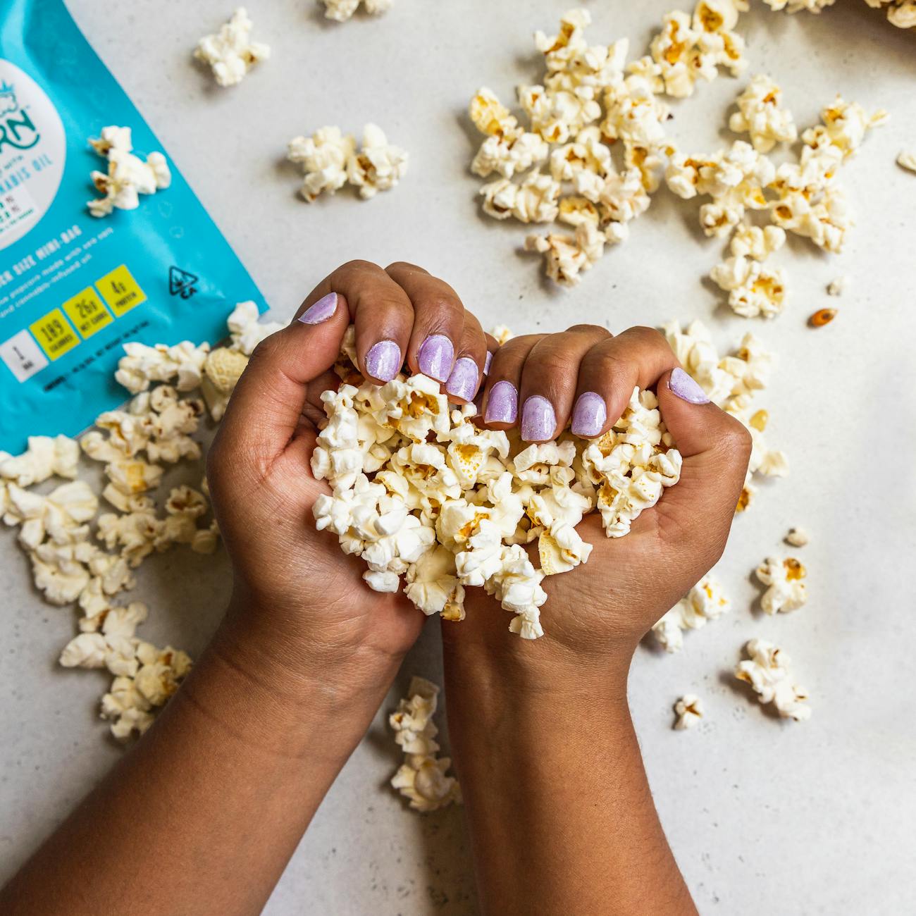 person s hands with popcorns