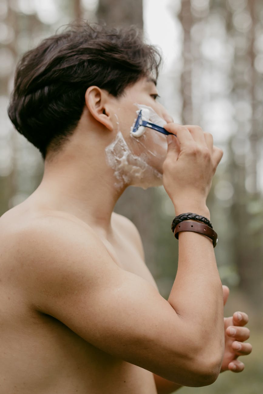 a man shaving his facial hair