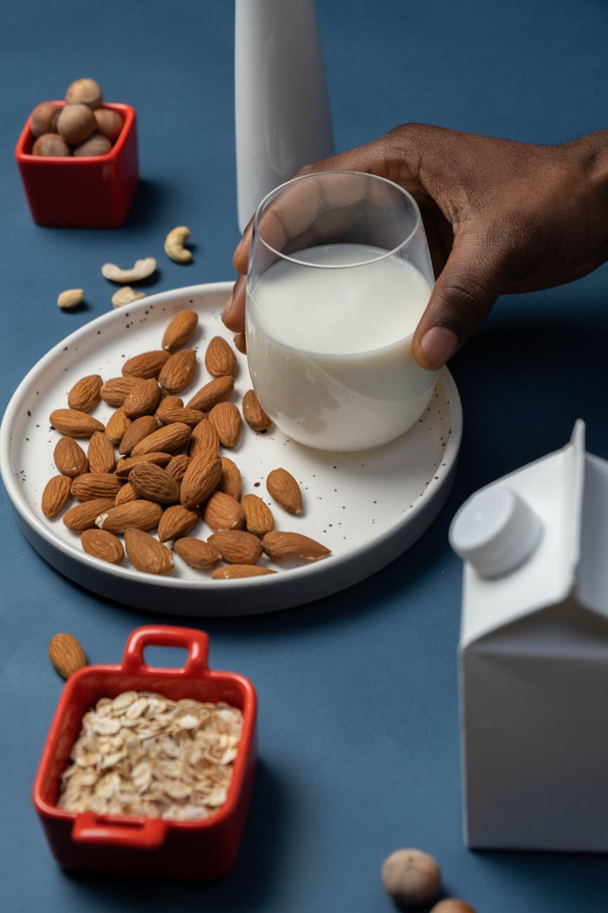 glass of almond milk in hand