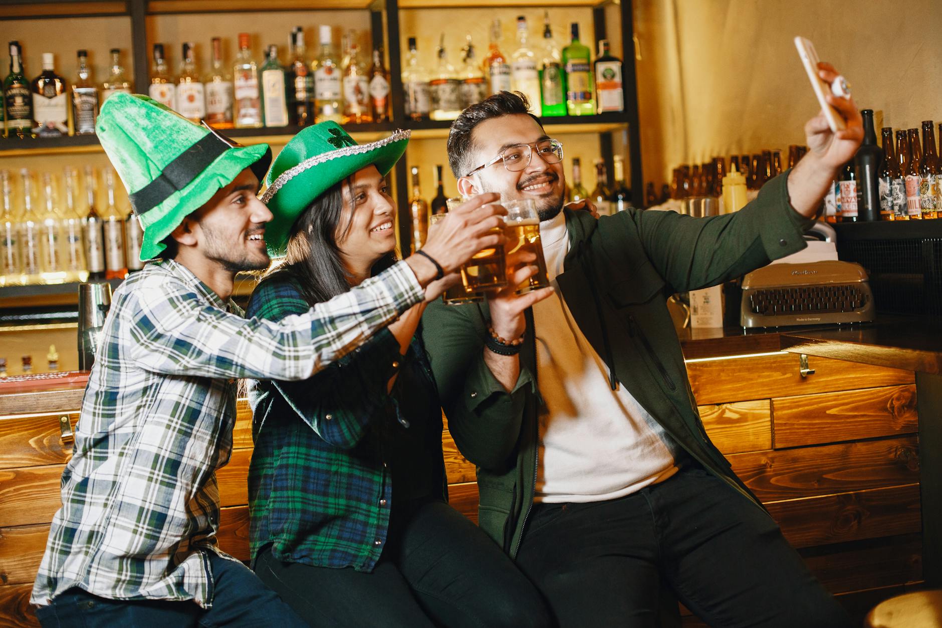 three people taking a photo in a pub