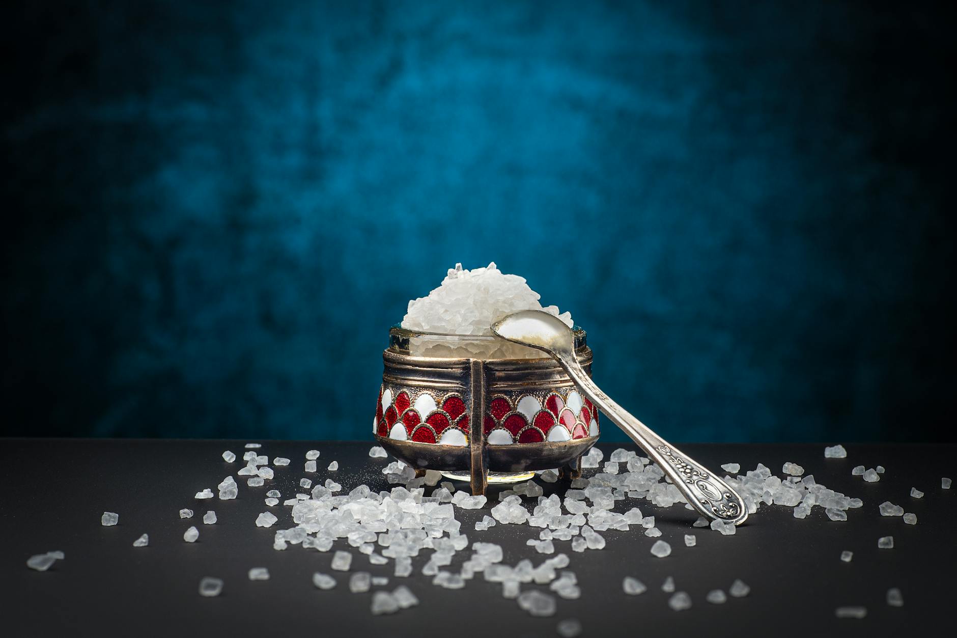 spoon on metal container with rock salt