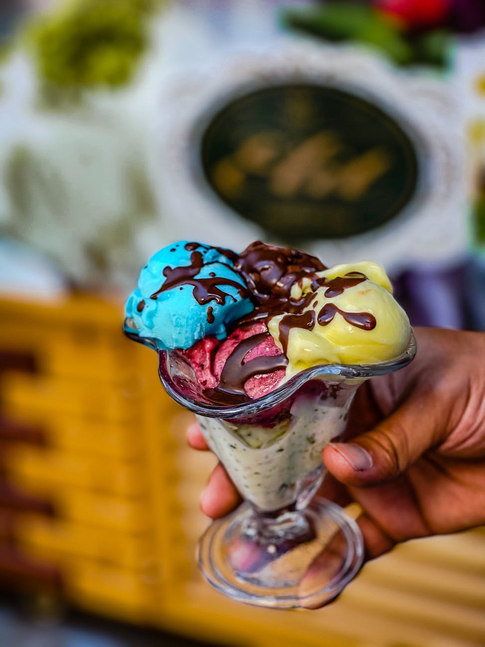 a person holding a parfait of ice cream